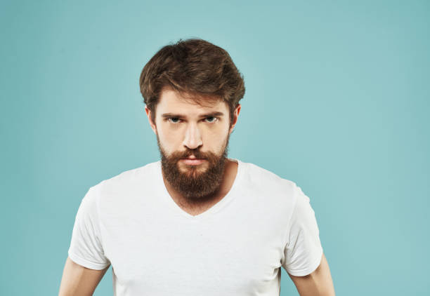 istock Cute man with beard on blue background emotions Copy Space cropped view 2150091029