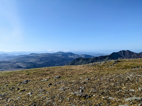 Walking from Glyder Fawr to Glyder Fach in the Snowdonia national park in North Wales. A beautiful mountain scene on what is a rugged hard mountain to climb. Beautiful views for miles, looking over Wales.