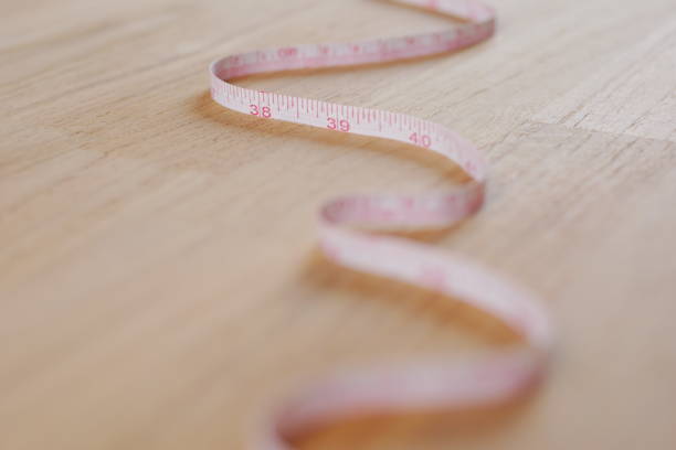 istock Measuring tape on woodenfloor 2150091439