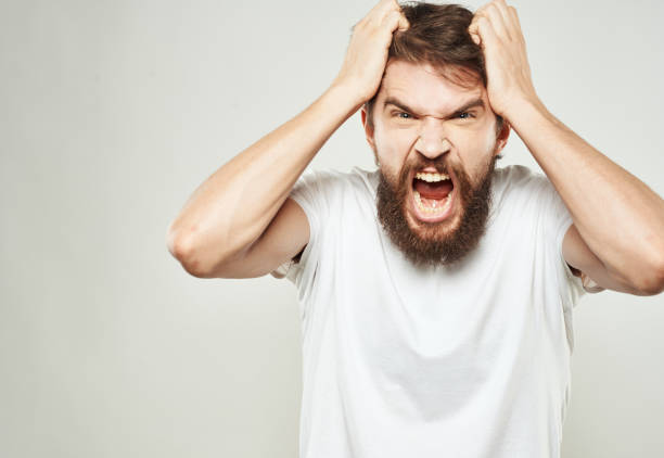istock Aggressive man gestures with his hands on a light background stress emotions irritability 2150091555