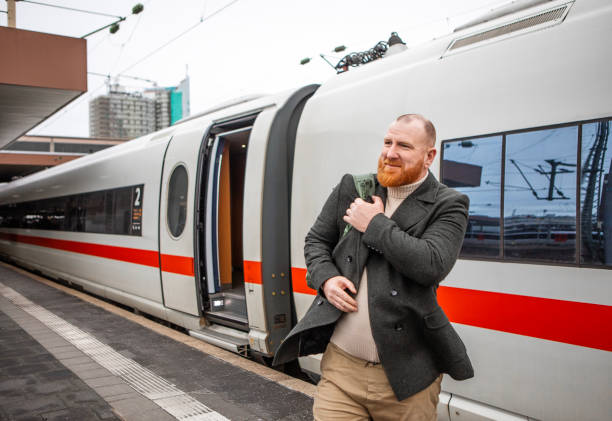 Redhead middle aged handsome male commuter travelling by train in Dusseldorf, Germany.
