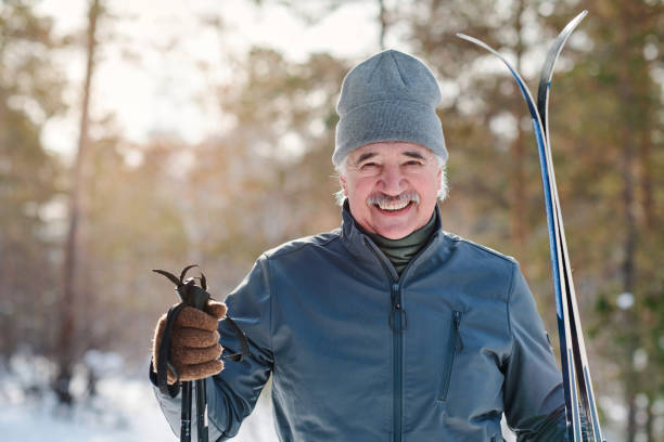 istock Happy Senior Man With Skis In Park 2150092750