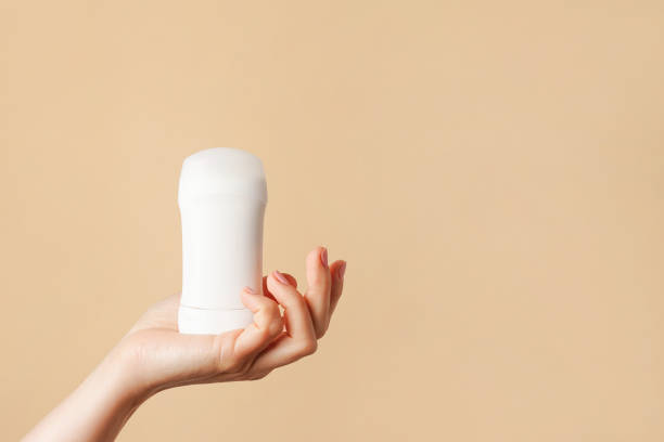 istock Woman hand holding white body deodorant on beige background, copy space 2150092956