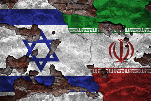 istock Flags of Iran and Israel displayed on a damaged brick wall 2150092957
