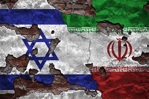 Iranian and Israeli Flags on Grunge textured surface