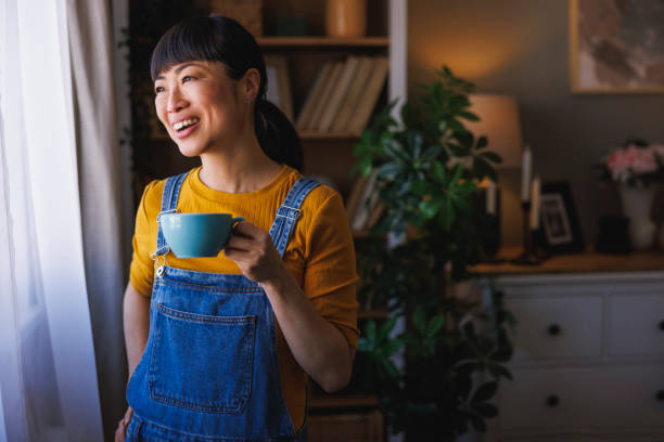 istock Woman drinking coffee while relaxing at home 2150093029