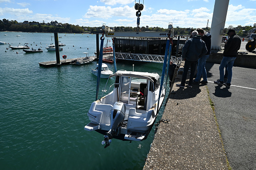 Dinard, France, april 18, 2024 : Motor boat winched for launching in the Dinard marina