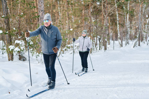 istock Man And Woman Skiing On Winter Day 2150094754