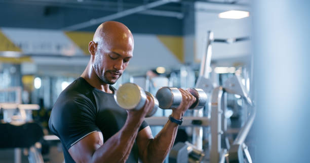 istock Gym, dumbbell and man in exercise as body builder in weightlifting training and thinking of progress. Healthy, fitness and commitment to workout challenge with iron weight in club for muscle growth 2150096112