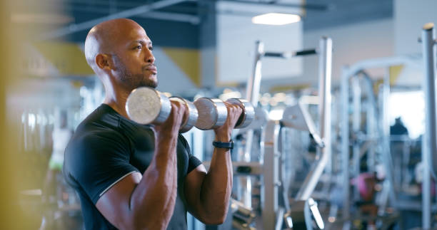 istock Iron, dumbbell and man in gym to exercise with weightlifting training and strong body builder. Healthy, fitness and commitment to workout challenge with heavy weight in club for muscle wellness 2150096346