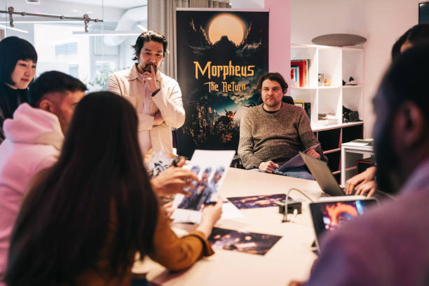 istock Group of diverse gaming designers, working with character sheets on their new virtual game 2150096544
