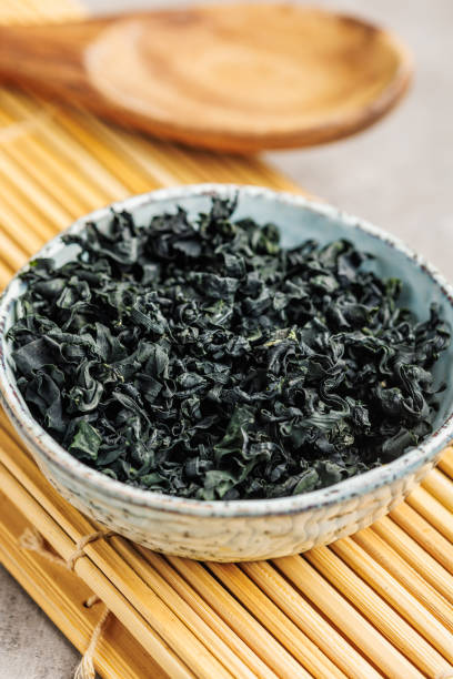 istock Dried wakame seaweed in bowl on kitchen table. 2150097140