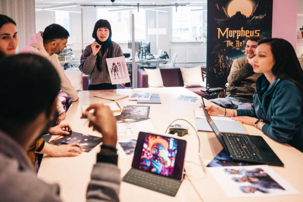 istock Group of diverse gaming designers, working with character sheets on their new virtual game 2150098202