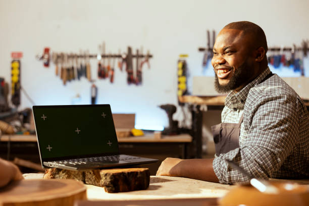 istock Joyful woodworker and coworker using CAD software on green screen laptop 2150098288