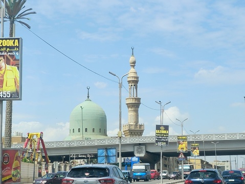 Cairo, Egypt, April 8 2024: El Haj Nouri Khatab Mosque in Nasr city Cairo, with a green dome and a high minaret, Masjid Nouri Khattab, Islamic place to perform the 5 prayers of the day for Muslims, selective focus