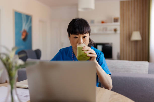 istock Female Doctor Drinks a Smoothie While Working From Home 2150098472