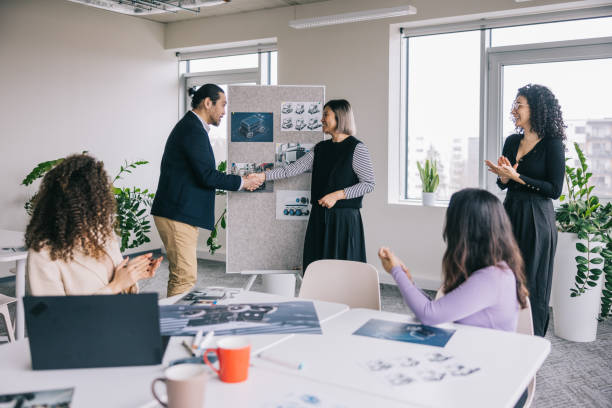 istock Business team cheering woman after successful presentation. 2150098721