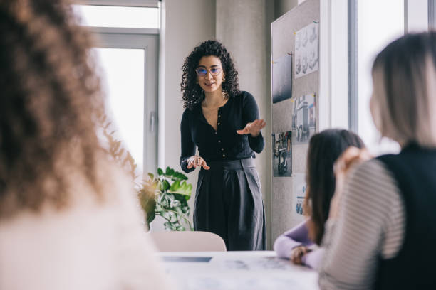 istock Latin woman making a presentation during team meeting. 2150098781