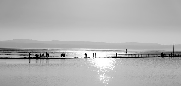View of marine lake ate west Kirby, Wirral, UK .  people can be seen walking round the lake.