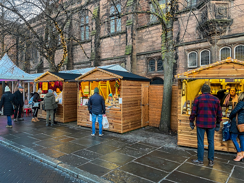 View across Chester Christmas market in the centre of Chester, UK.  People can be seen on the promenade