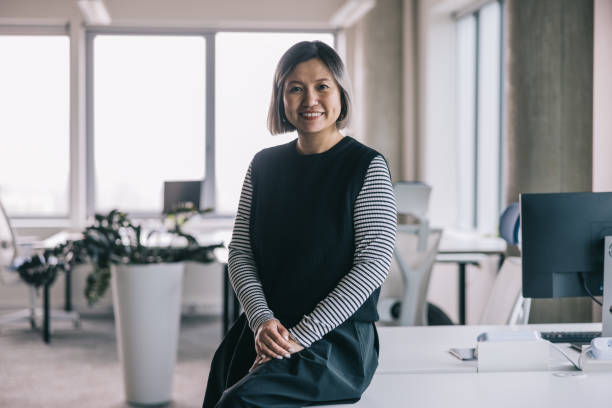 istock Smiling Chinese woman at the office 2150100356