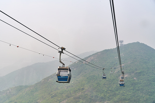 Hong Kong, China - April 15, 2023: Ngong Ping 360 cable car on a foggy day.