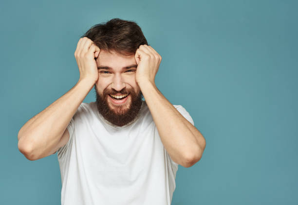 istock Emotional man on a blue background gestures with his hands surprise model delight 2150104754