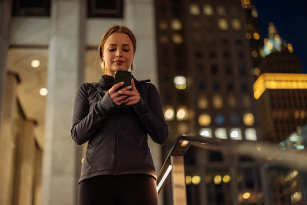 istock Woman using smartphone in city at night 2150105002