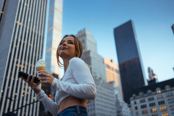 istock Woman reaches for ice cream in urban setting 2150106313