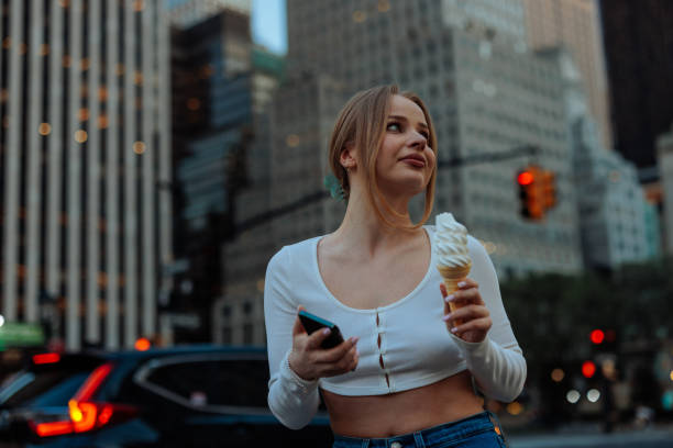 istock Delighted woman with ice cream looks up 2150106423