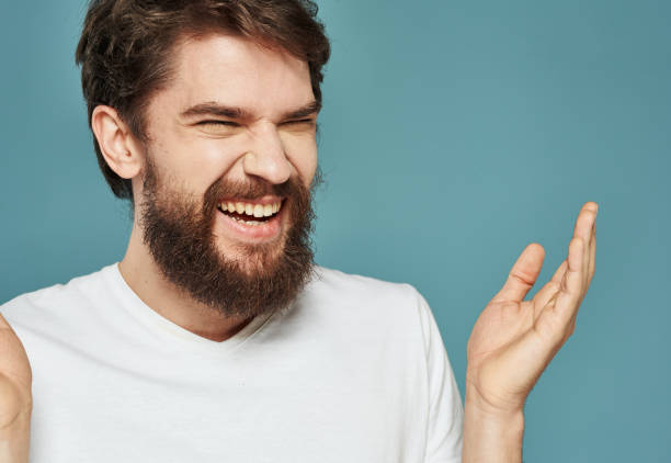 istock Happy man joy delight emotions blue background thick beard 2150106503