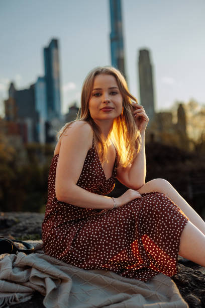 istock Woman posing in park at sunset 2150107259