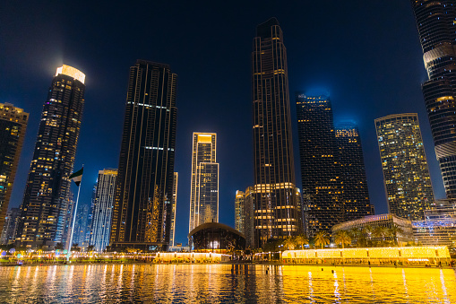 Low-angle view of skyscrapers and modern buildings by the waterfront in Dubai city centre, United Arab Emirates