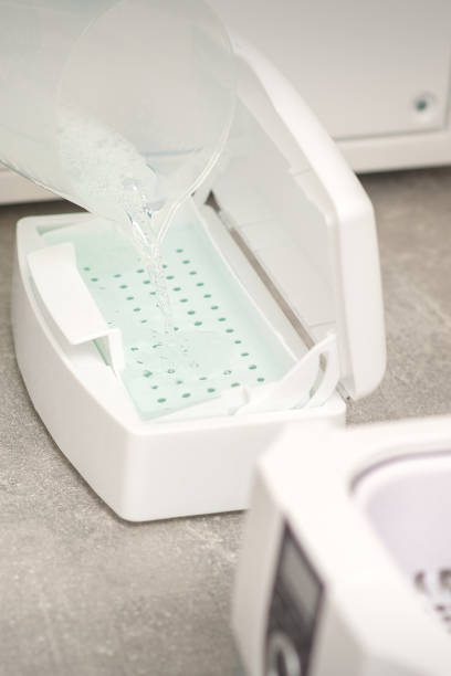 istock Adding liquid for disinfection of instruments to the machine for sterilization of tools. 2150107669