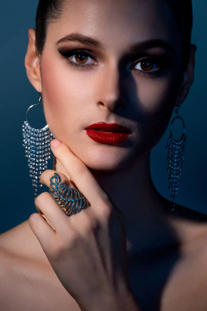 istock Elegant woman posing in dramatic blue lighting 2150109221