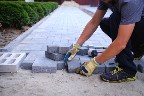 istock The master in yellow gloves lays paving stones 2150110811