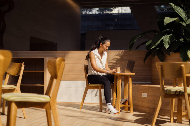 istock Young Thai woman using laptop in coffee shop. 2150110831