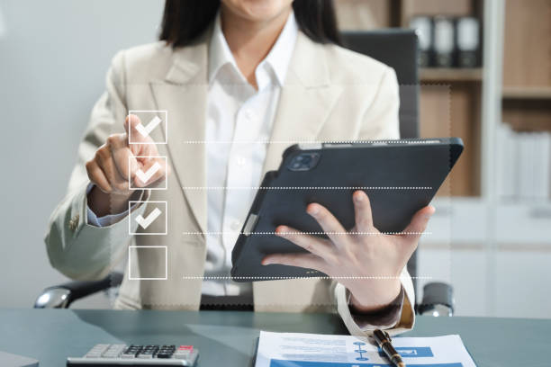istock Business performance checklist concept, businesswoman using tablet and laptop doing online checklist survey, filling out digital form checklist. 2150111588