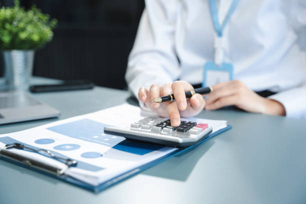 istock Business woman or financial data analysts working with smartphone and laptop computers and data graphs together. Plan to analyzing projects in the office. 2150111606