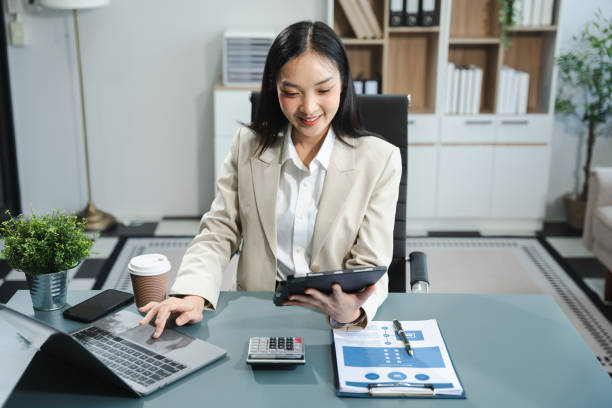 istock Business woman or financial data analysts working with smartphone and laptop computers and data graphs together. Plan to analyzing projects in the office. 2150111615