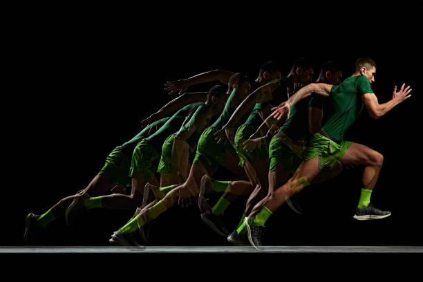 Concentrated and focused man, athlete in motion, running, training against black background with stroboscope effect. Concept of sport, active and healthy lifestyle, endurance and strength