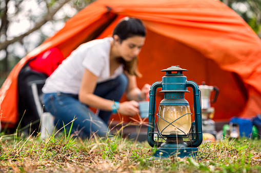 Camping outdoor themes: Hispanic young  woman camping in the forest
