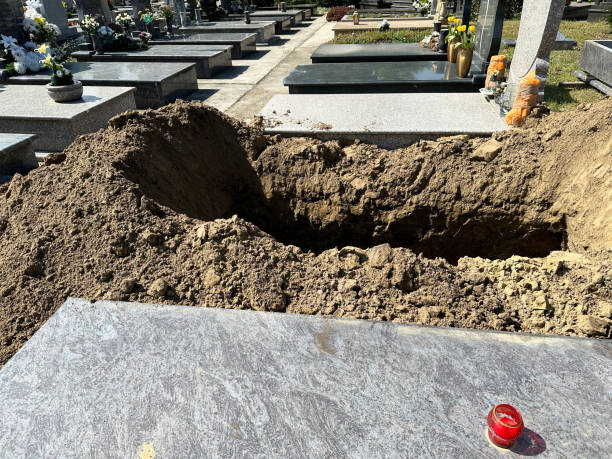 istock Newly dug out grave site in the public cemtery 2150115021