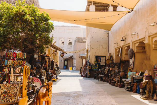 Shopping at Traditional Market at Historical District of Dubai Old Town Flea market at the old streets with authentic Persian buildings at Bastakiya district of Dubai city by the bay, United Arab Emirates historic-district stock pictures, royalty-free photos & images