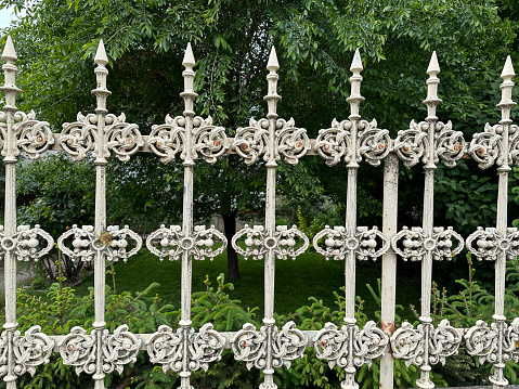 black forged metal fence on a white background