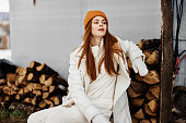 woman on winter clothes firewood on the outdoors Lifestyle