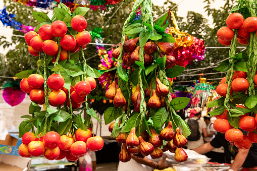 Colorful, paper fruit sculptures, including apples, figs and clementines, sold for decorating the sukkah, a temporary booth or shelter used in the celebration of the Jewish holiday of Sukkot.