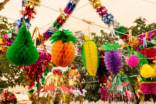 Colorful, paper fruit sculptures, including pears, oranges and grapes, sold for decorating the sukkah, a temporary booth or shelter used in the celebration of the Jewish holiday of Sukkot.