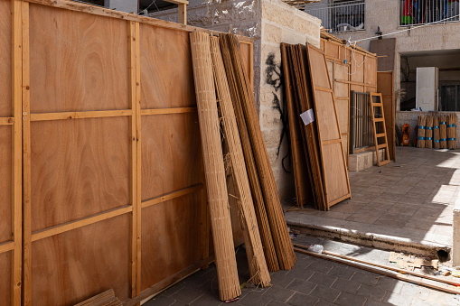 A street scene in Jerusalem during Sukkot, in which temporary, wooden or fabric structures called a sukkah are erected as part of the ritual observance of the weeklong Jewish holiday that recalls the ancient journey of the Israelites from Egypt through the desert to what is now the modern state of Israel.
