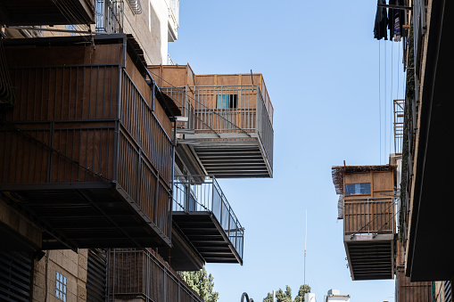 Residential buildings in Jeruslaem, Israel, during the holiday of Sukkot, in which temporary, wooden structures called a sukkah are placed on streets and balconies as part of the ritual observance of the weeklong Jewish  festival that recalls the ancient journey of the Israelites from Egypt through the desert to what is now the modern state of Israel.
